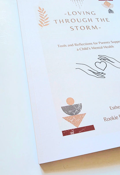 Paperback Book titled 'Loving Through the Storm' on a light background