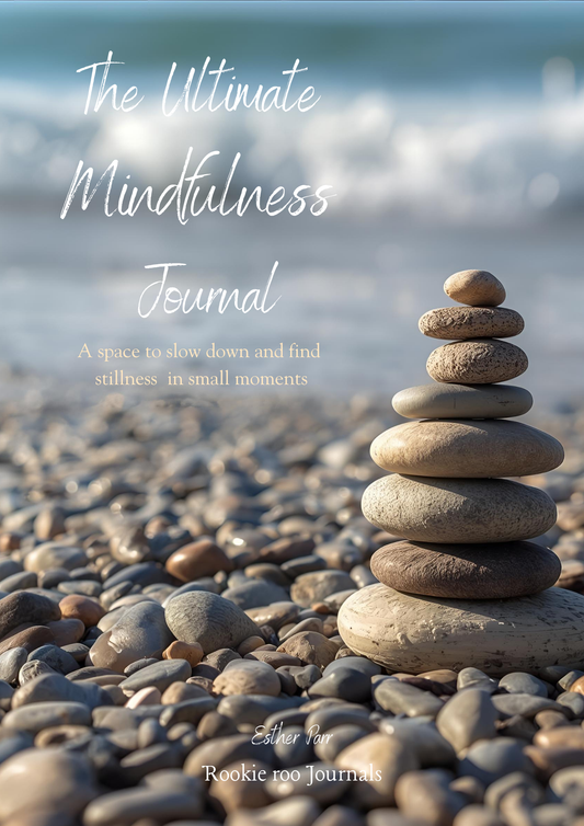 Mindfulness journal cover with stacked stones on a pebble beach