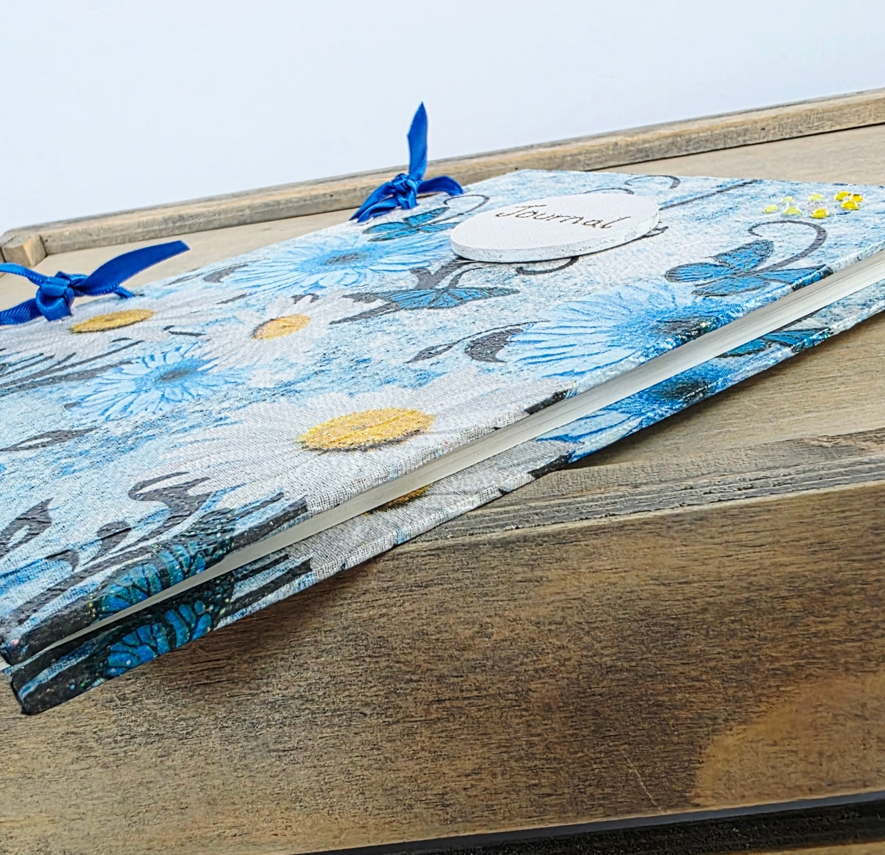 blue floral wooden journal showing the edge