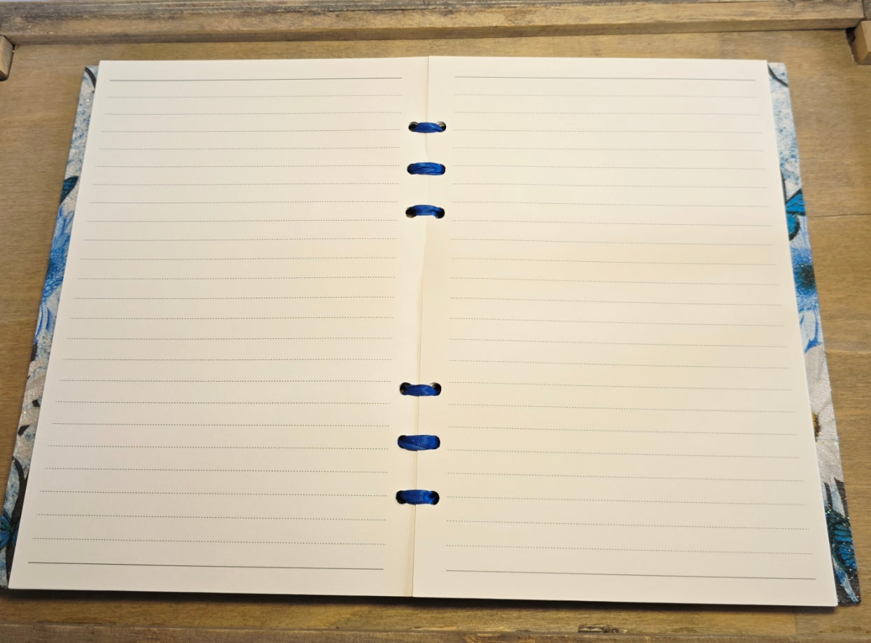 Open notebook with lined pages on a wooden surface