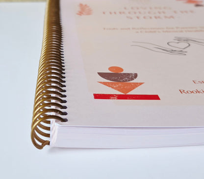 Close-up of a spiral-bound book with a logo on a white background