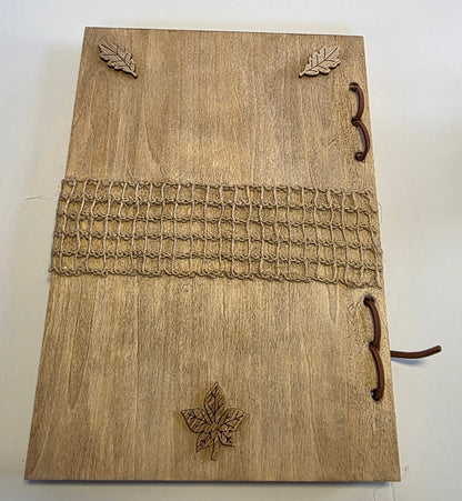 Wooden journal back cover with leaf designs and a woven pattern on a white background