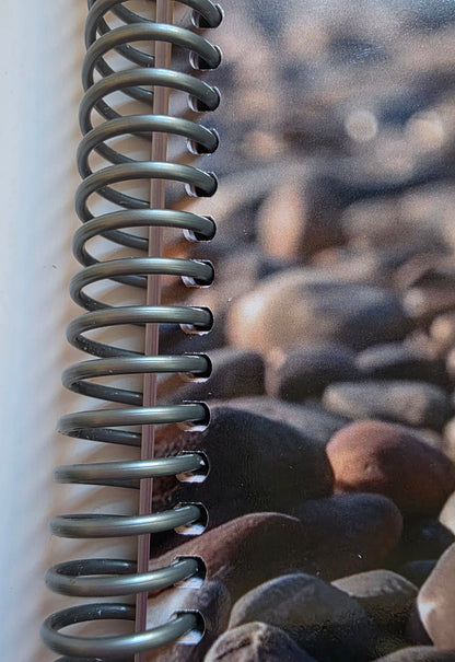 Metallic spiral spring on the side of a notebook
