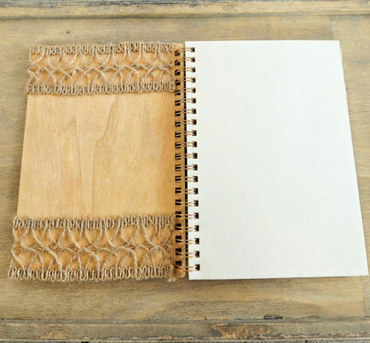 Open wooden notebook with a decorative burlap inside cover. Spiral bound with plain pages