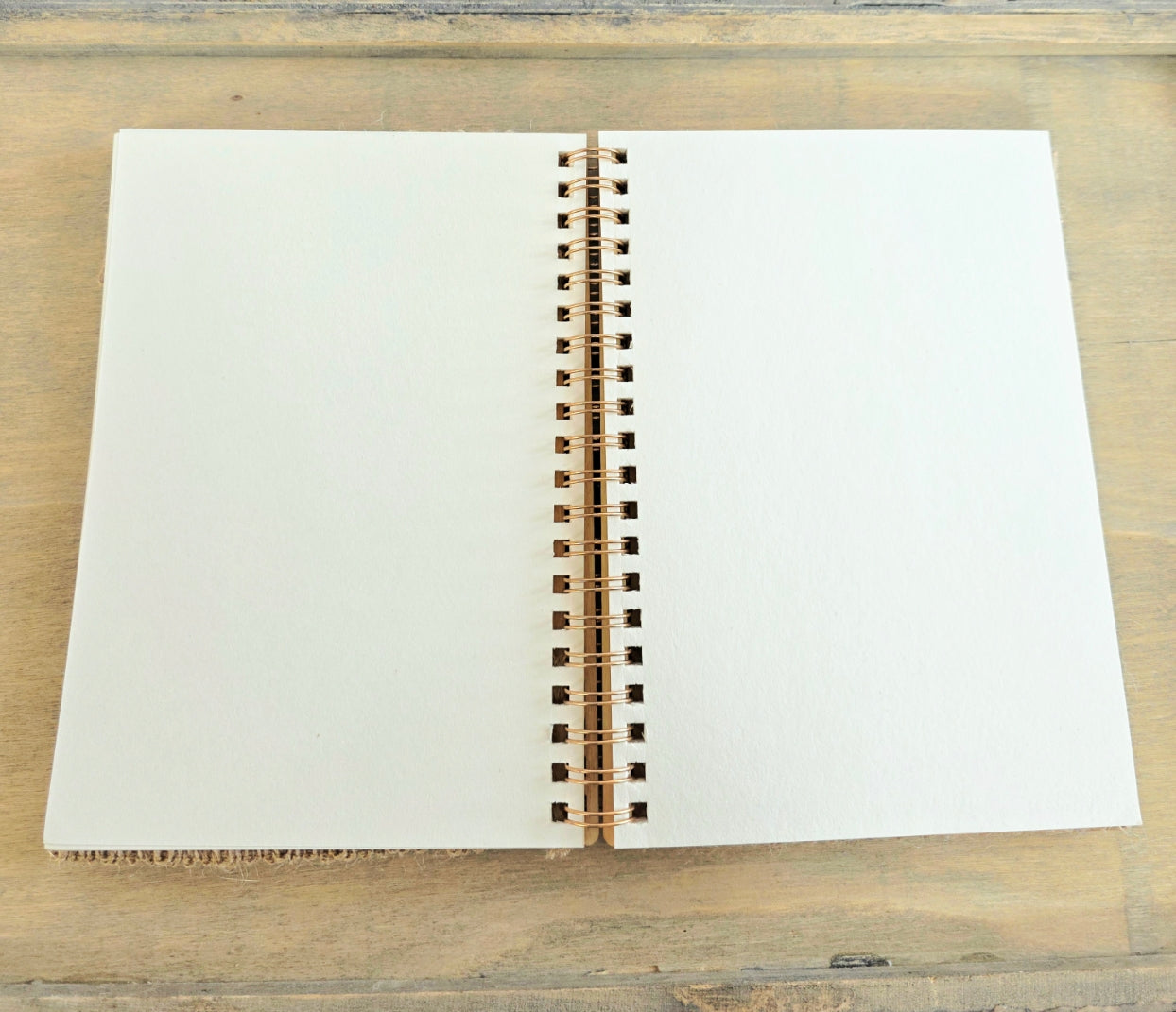 Open notebook with blank pages. Metal spiral bound