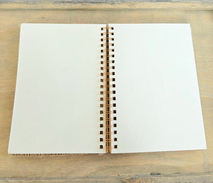 Open notebook with blank pages. Metal spiral bound