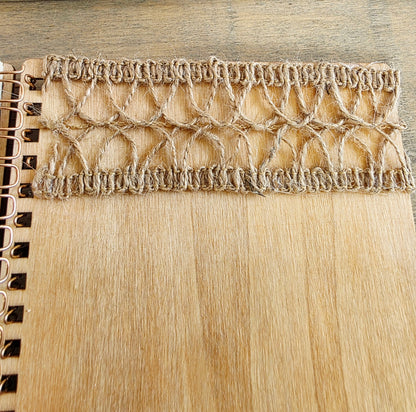 Close-up of a burlap texture on a wooden spiral bound notebook
